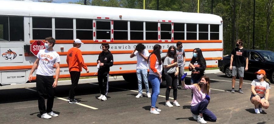 Seniors gathered, socially distanced, at a surprise distribution of their caps & gowns in mid-May.