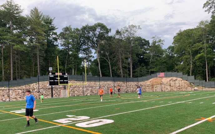 The first day of football practice saw players close in spirit but far in distance.